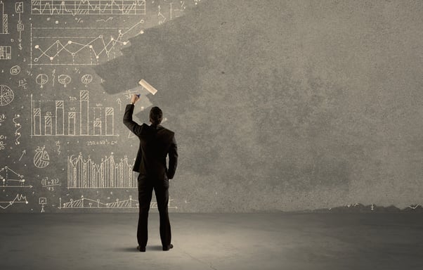 An elegant businessman covering pie charts, statistics, numbers, data, graphs on urban concrete wall with fresh paint using a roller concept