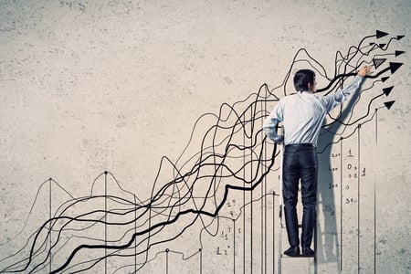 Back view image of businessman drawing graphics on wall-1