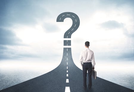 Business person looking at road with question mark sign concept-1