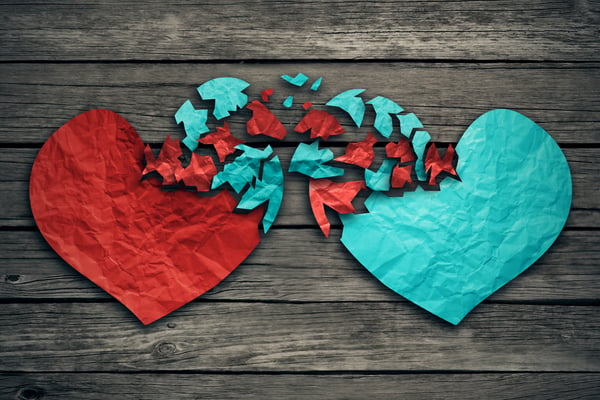 Romantic relationship concept as two hearts made of torn crumpled paper on weathered wood as symbol for romance attachment and exchange of feelings and emotions of love.-1