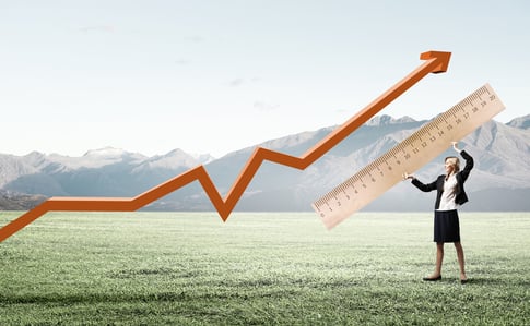 Young businesswoman measuring something with big ruler-1