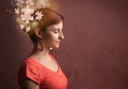 Young person thinking with glowing puzzle mind on grungy background