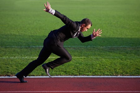 business man in start position ready to run and sprint on athletics racing track-1