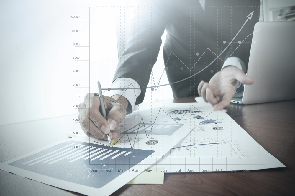 close up of businessman hand working on laptop computer with business graph information diagram on wooden desk as concept-Feb-29-2024-12-23-38-7958-AM