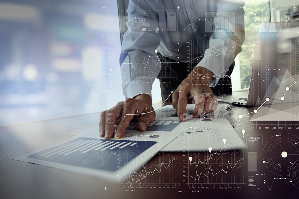 close up of businessman hand working on laptop computer with financial business graph information diagram on wooden desk as concept-3