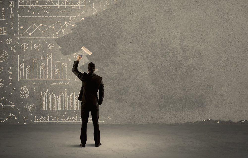 An elegant businessman covering pie charts, statistics, numbers, data, graphs on urban concrete wall with fresh paint using a roller concept