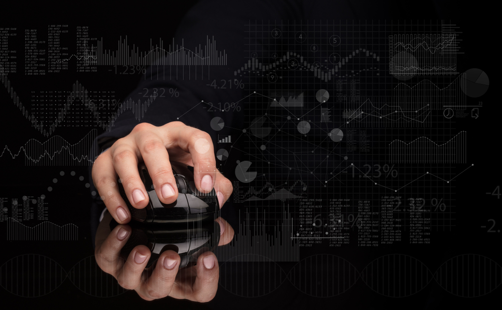 Hand using wireless mouse with financial concept on dark background-1